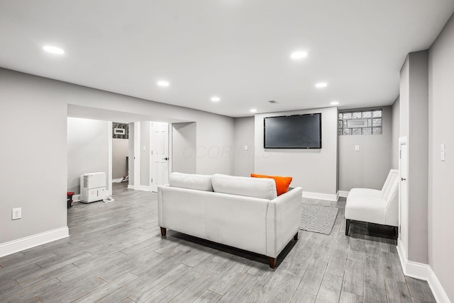 living area with recessed lighting, wood finished floors, and baseboards