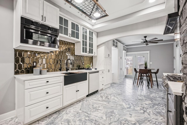 kitchen with dishwasher, decorative backsplash, marble finish floor, stainless steel gas range, and a sink