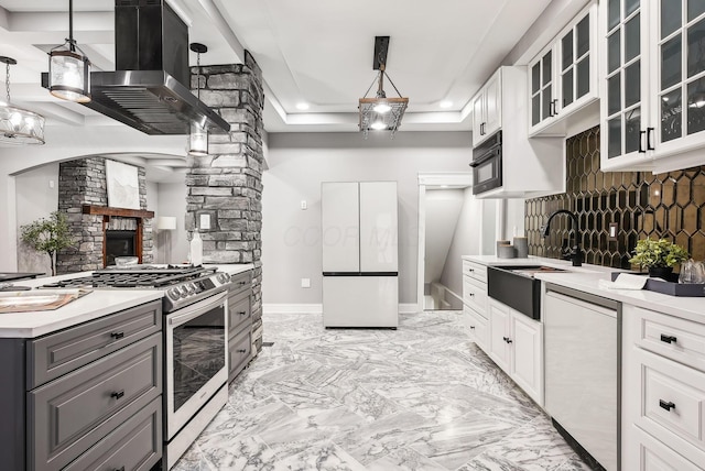 kitchen featuring gas stove, gray cabinets, a sink, dishwasher, and island range hood