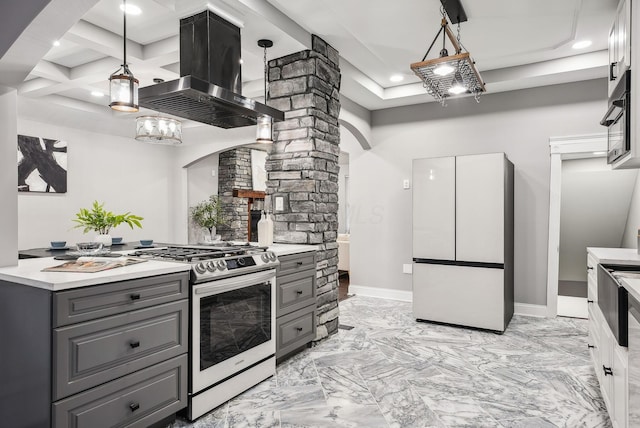 kitchen with stainless steel range with gas cooktop, gray cabinets, freestanding refrigerator, light countertops, and island range hood