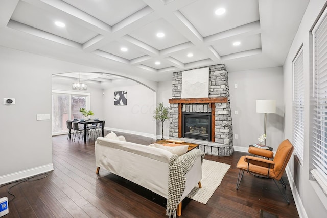 living area featuring coffered ceiling, baseboards, and hardwood / wood-style flooring