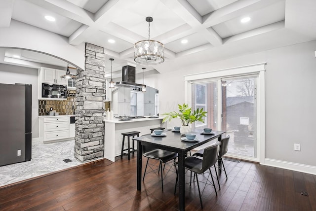 dining area with coffered ceiling, baseboards, ornate columns, and hardwood / wood-style flooring