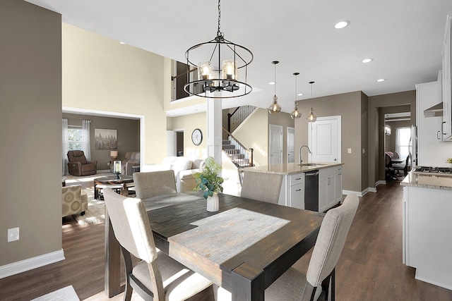 dining area with dark wood-type flooring, stairway, baseboards, and a wealth of natural light