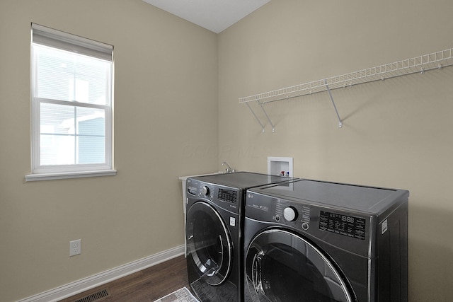 laundry room featuring laundry area, dark wood-type flooring, baseboards, and separate washer and dryer