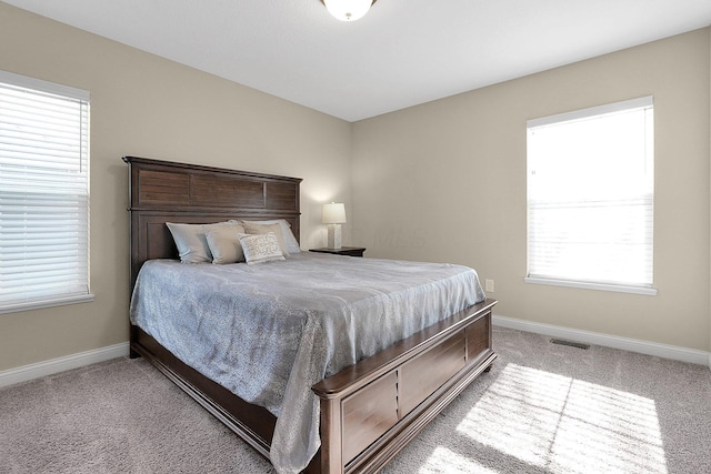 bedroom with visible vents, carpet flooring, and baseboards