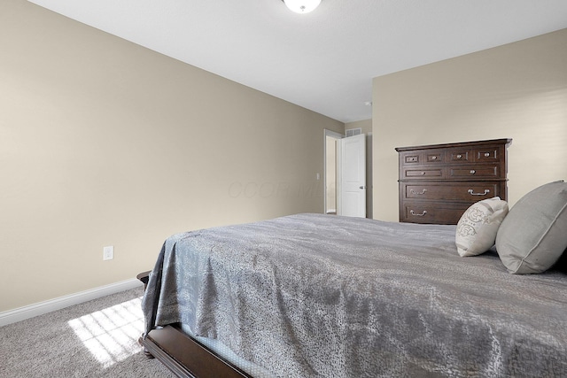 carpeted bedroom with visible vents and baseboards