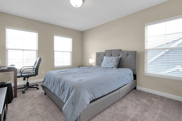 carpeted bedroom featuring baseboards