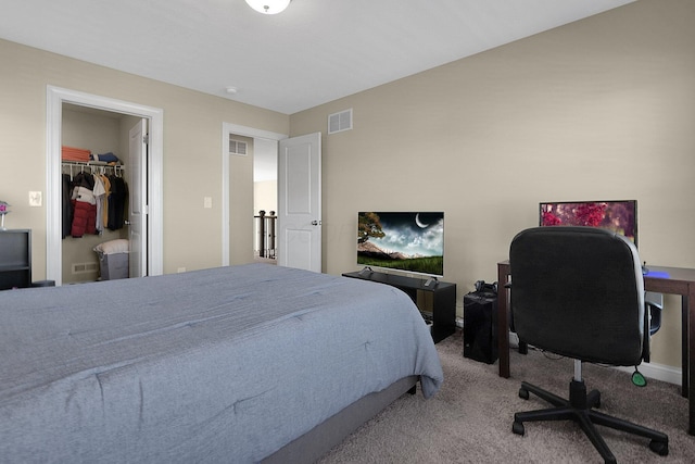 carpeted bedroom with visible vents and a spacious closet