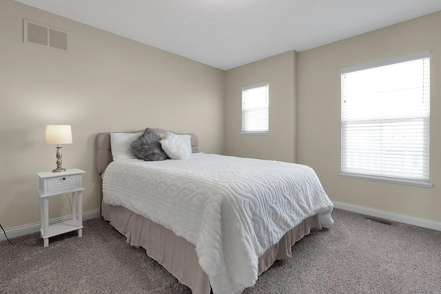 bedroom featuring visible vents, baseboards, and light colored carpet