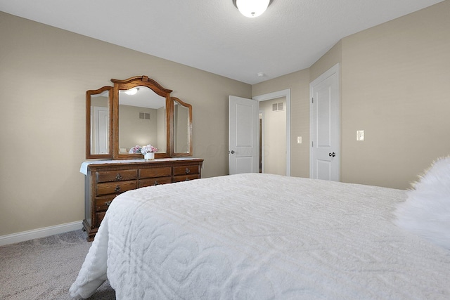 carpeted bedroom with baseboards and visible vents