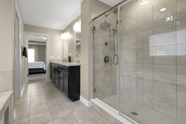 ensuite bathroom with connected bathroom, baseboards, vanity, and a shower stall