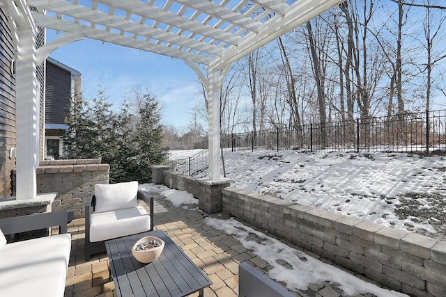 snow covered patio featuring outdoor lounge area, a fenced backyard, and a pergola