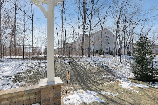 yard covered in snow with fence