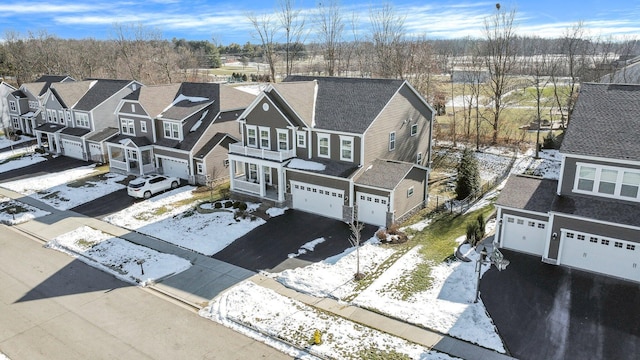 snowy aerial view with a residential view