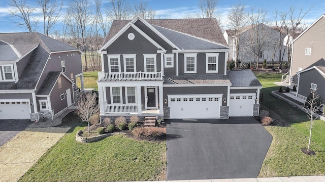 1241 Mcclish Ct, Grove City, OH 43123 - view of front of property featuring driveway, covered porch, a balcony, stone siding, and a shingled roof
