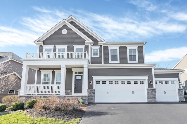 1241 Mcclish Ct, Grove City, OH 43123 - view of front of home with covered porch, asphalt driveway, a balcony, and stone siding