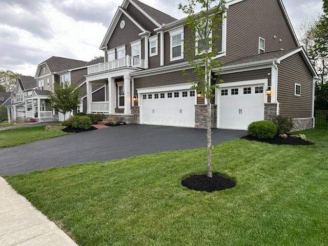 1241 Mcclish Ct, Grove City, OH 43123 - view of front of property with an attached garage, driveway, stone siding, a front lawn, and a balcony