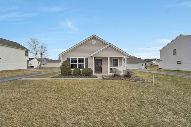 bungalow-style home featuring a front lawn and covered porch