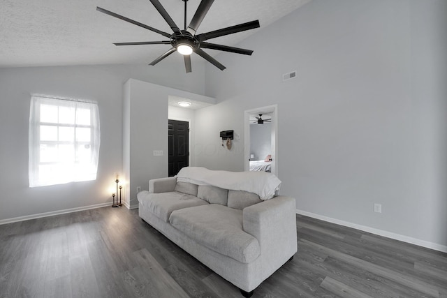 living area with visible vents, a textured ceiling, baseboards, lofted ceiling, and dark wood-style flooring