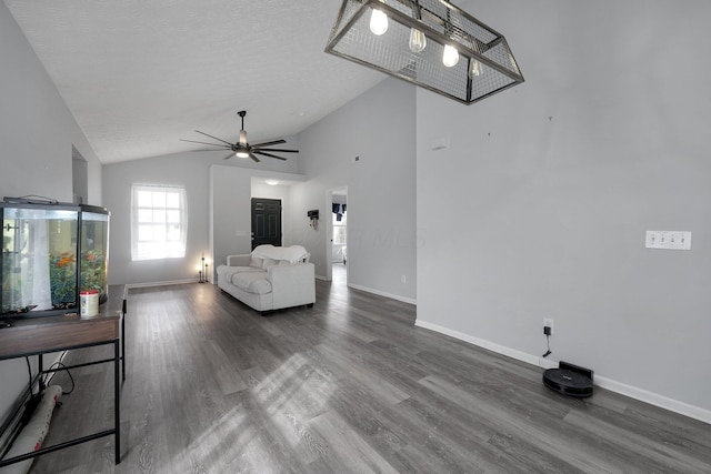 living room with high vaulted ceiling, a ceiling fan, a textured ceiling, wood finished floors, and baseboards