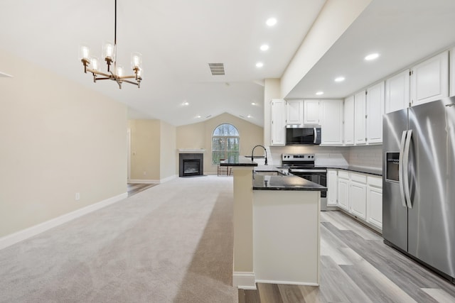 kitchen with white cabinets, recessed lighting, visible vents, dark countertops, and stainless steel appliances