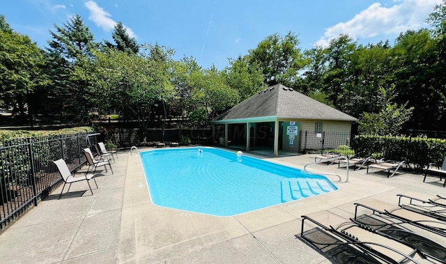 pool featuring a patio area and fence