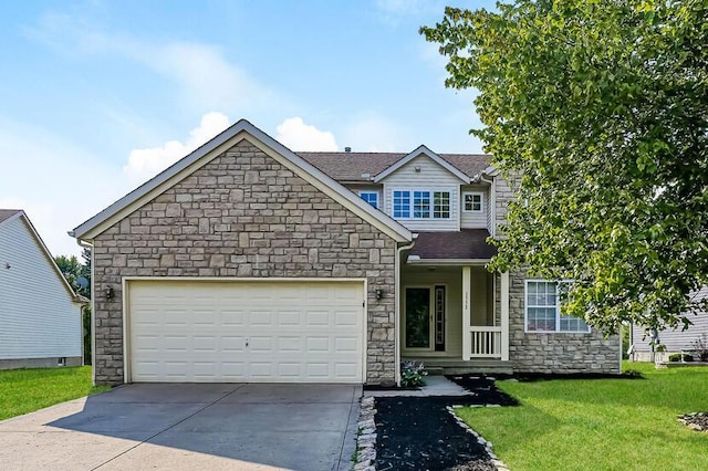 traditional-style home with a front lawn, an attached garage, driveway, and a shingled roof