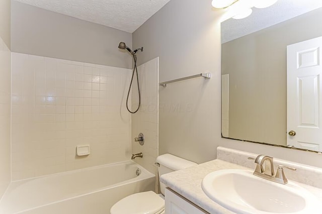 full bathroom with shower / bathing tub combination, a textured ceiling, vanity, and toilet