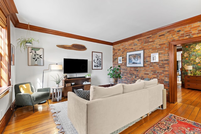 living room featuring brick wall, crown molding, and wood-type flooring