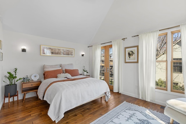 bedroom with multiple windows, access to exterior, and hardwood / wood-style flooring