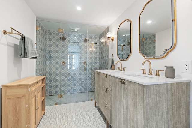 bathroom with double vanity, a shower stall, tile patterned floors, and a sink