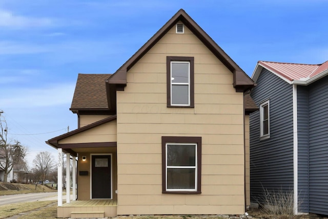 exterior space with roof with shingles