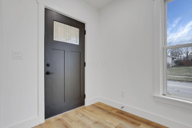 entrance foyer with light wood-type flooring and baseboards