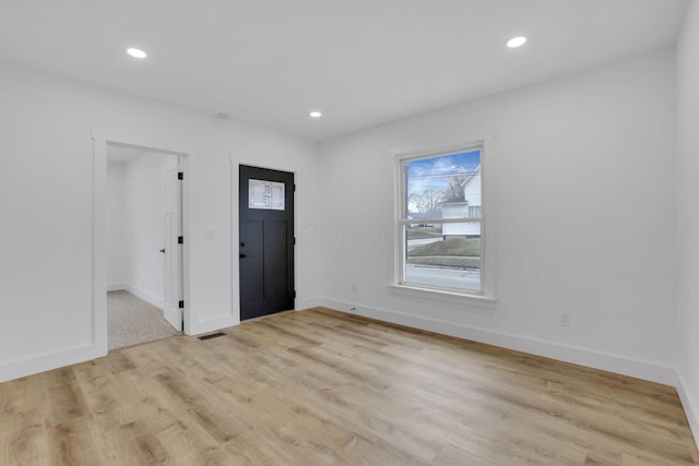 entrance foyer featuring recessed lighting, visible vents, light wood-style flooring, and baseboards