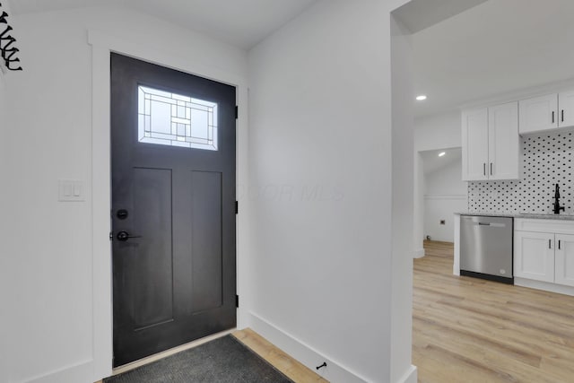 entrance foyer featuring recessed lighting, baseboards, and light wood finished floors