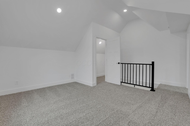 bonus room with baseboards, lofted ceiling, and carpet