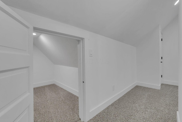 bonus room with vaulted ceiling, baseboards, and carpet floors