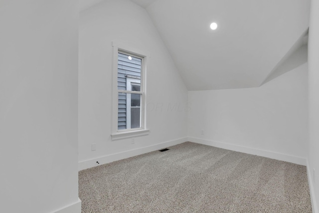 bonus room featuring lofted ceiling, baseboards, visible vents, and carpet floors