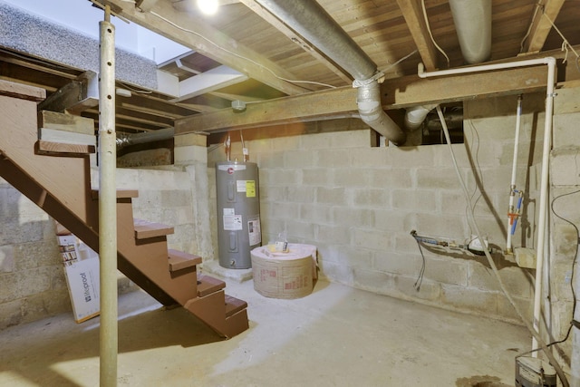 unfinished below grade area featuring electric water heater and stairs