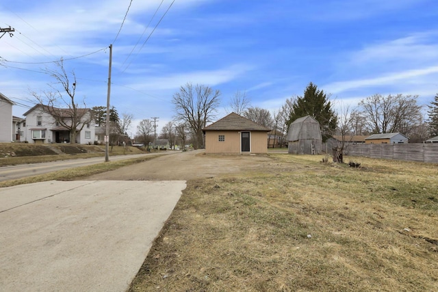 view of yard with an outdoor structure and fence