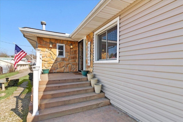 doorway to property featuring stone siding