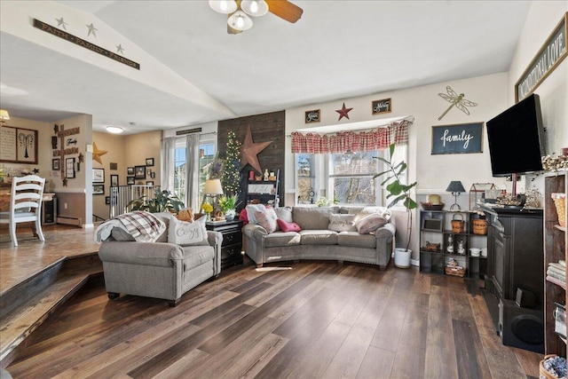 living room featuring a healthy amount of sunlight, a ceiling fan, lofted ceiling, and dark wood-style flooring