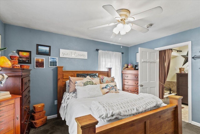 bedroom featuring baseboards, dark colored carpet, and ceiling fan