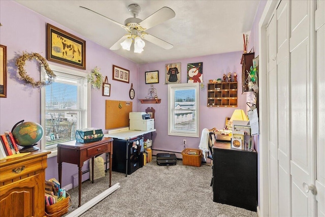 carpeted office with baseboard heating and a ceiling fan