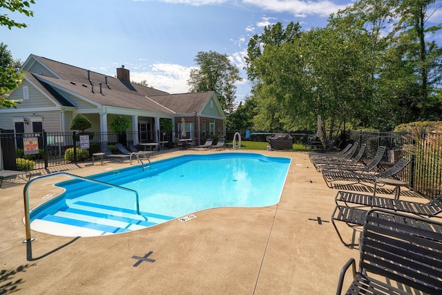 pool featuring a patio and fence