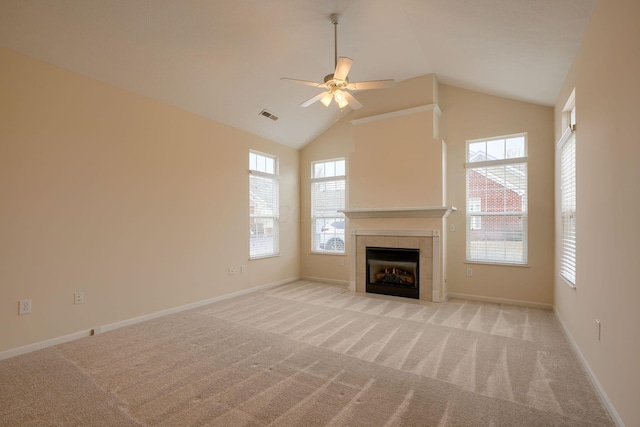 unfurnished living room featuring light carpet, high vaulted ceiling, a ceiling fan, a fireplace, and baseboards