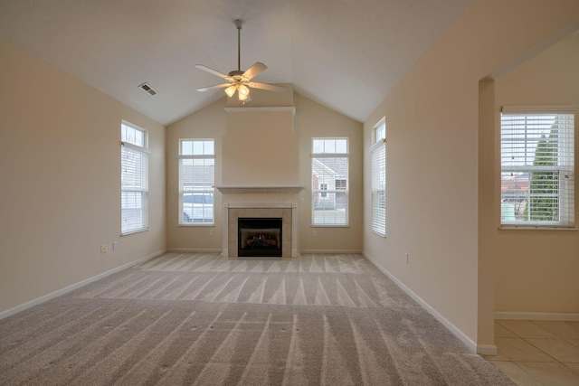 unfurnished living room with plenty of natural light, light colored carpet, and visible vents