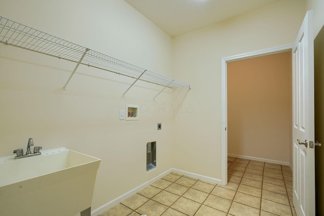 clothes washing area with a sink, light tile patterned floors, hookup for an electric dryer, hookup for a washing machine, and laundry area