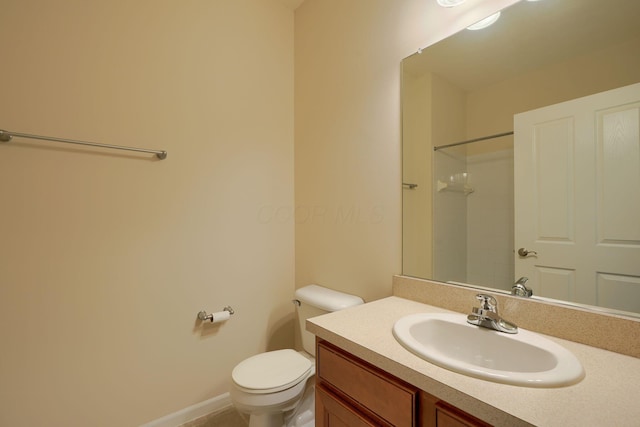 bathroom with a shower, toilet, and vanity