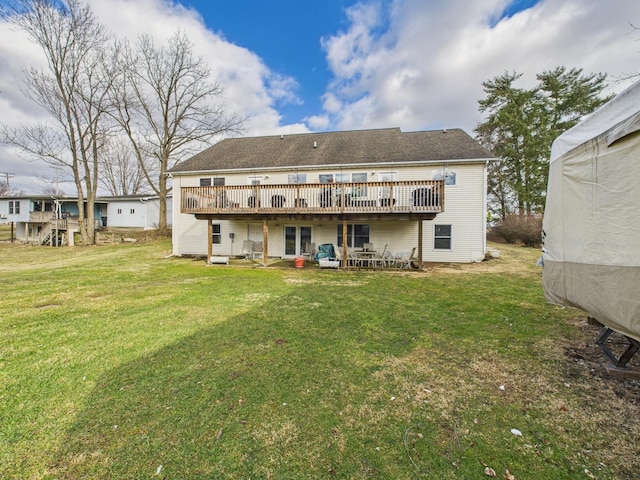 rear view of property with a patio area, a lawn, and a wooden deck